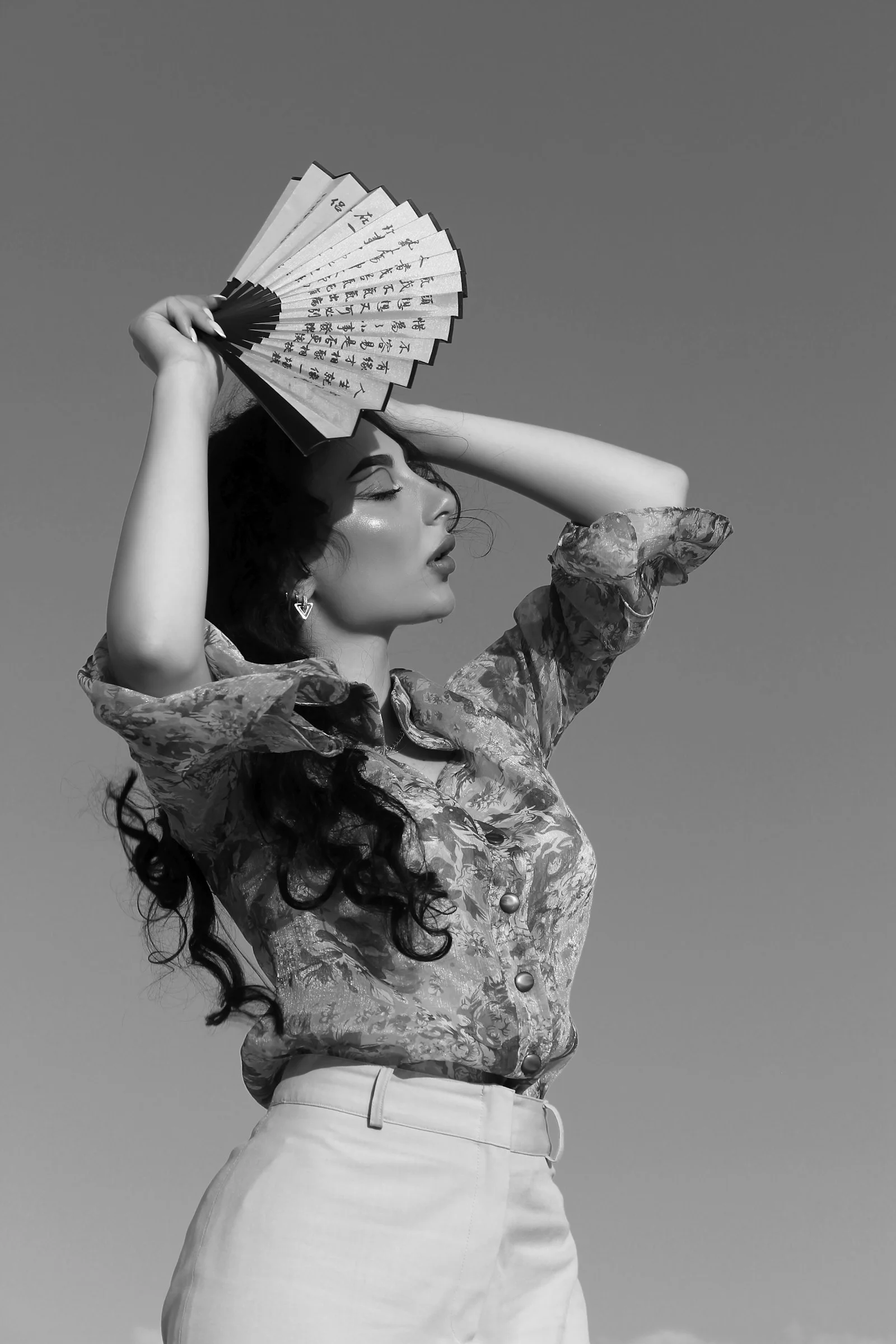 a woman with a fan on her head