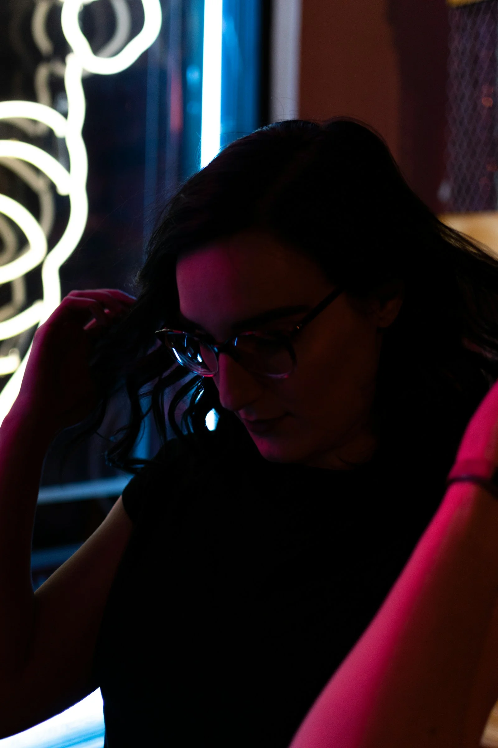 woman wearing eyeglasses holding hair