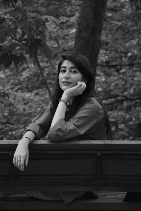 A woman sitting on a bench in the woods