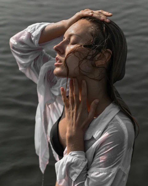 a person with the hands on the face