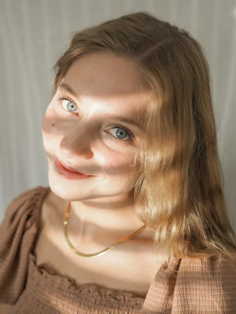 a woman with blue eyes and blonde hair