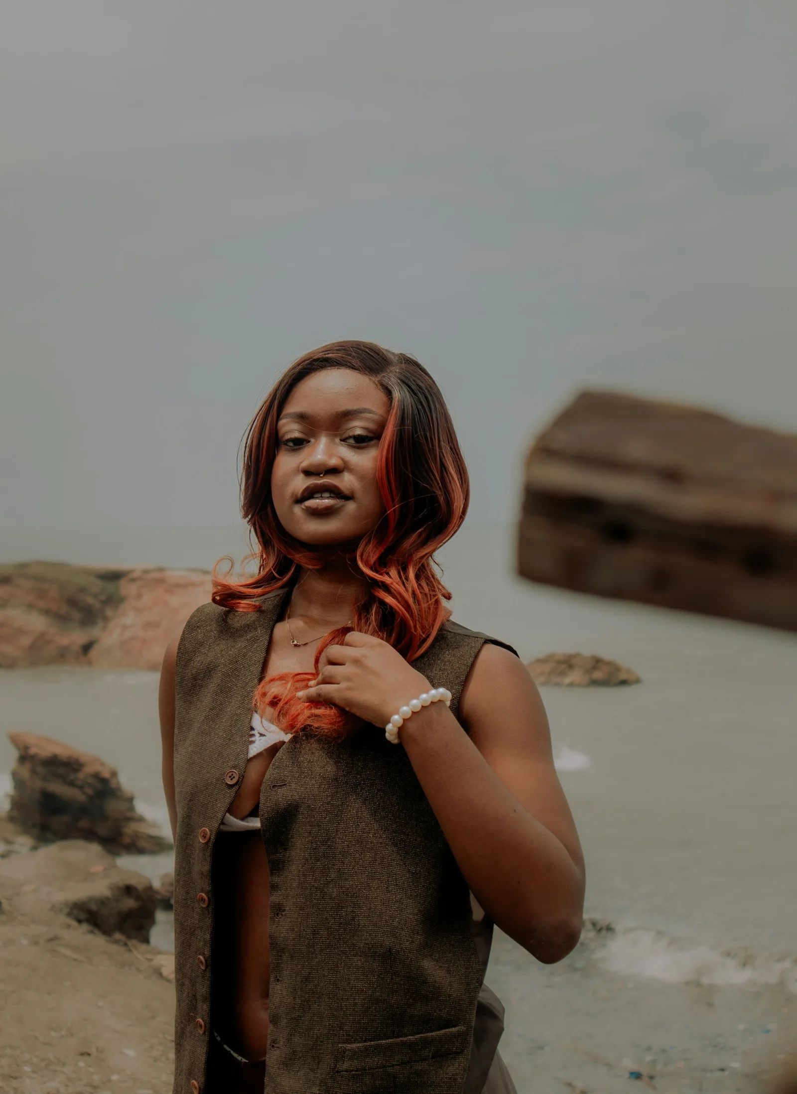 A woman standing in front of a body of water