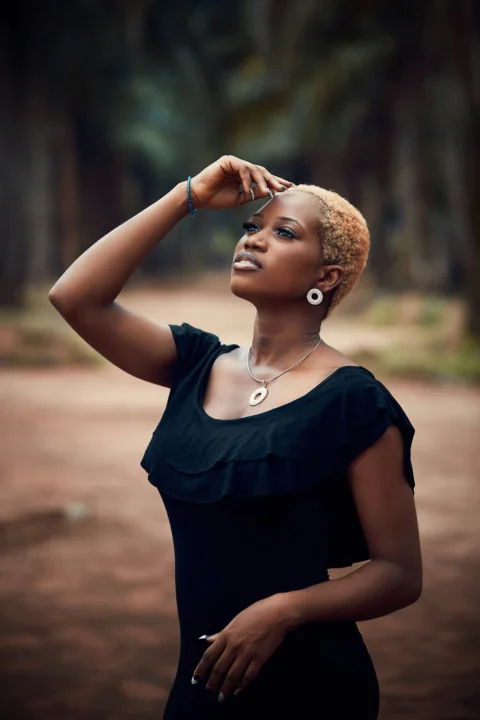 A young woman with short blonde hair looks up
