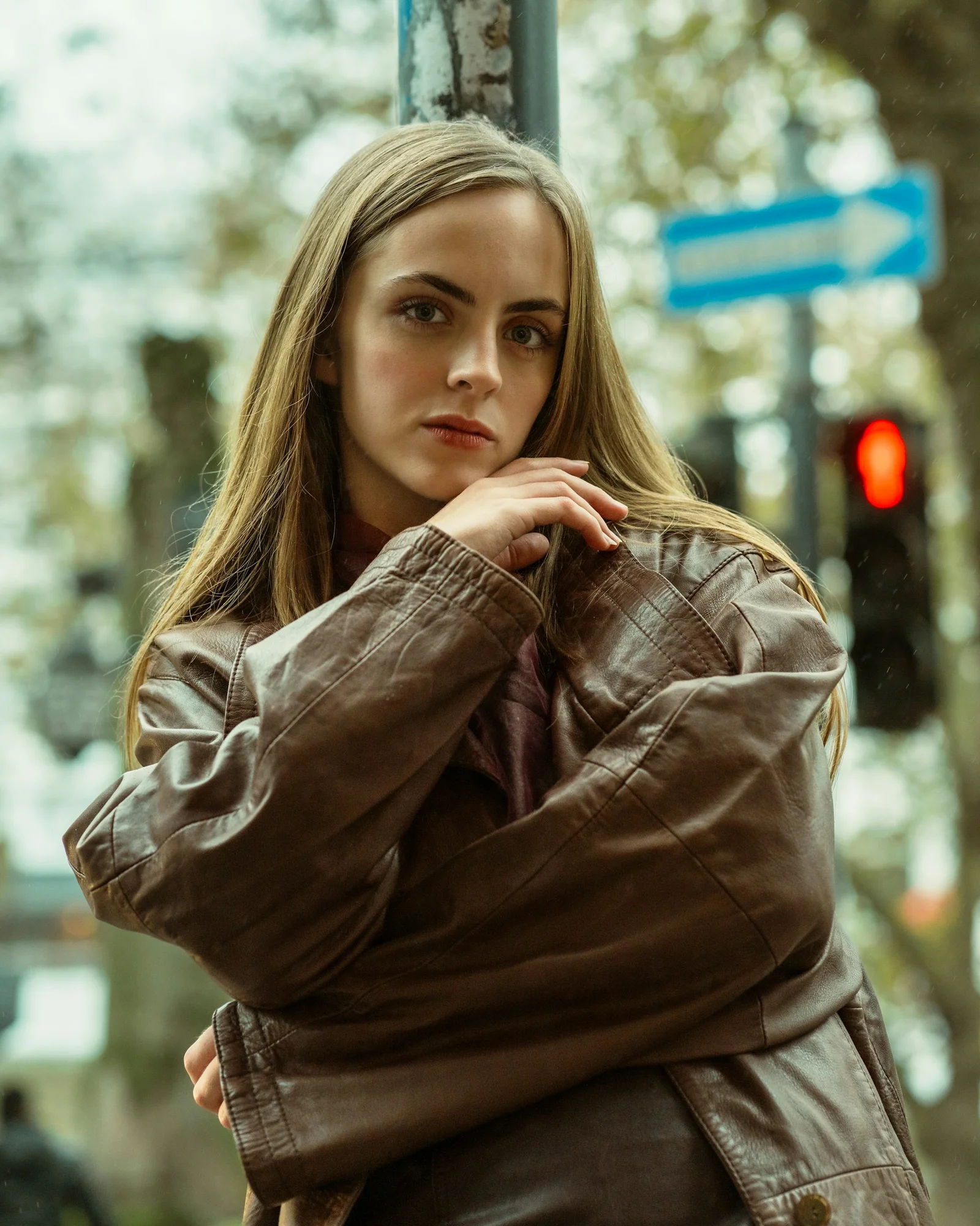 A woman poses on a city street