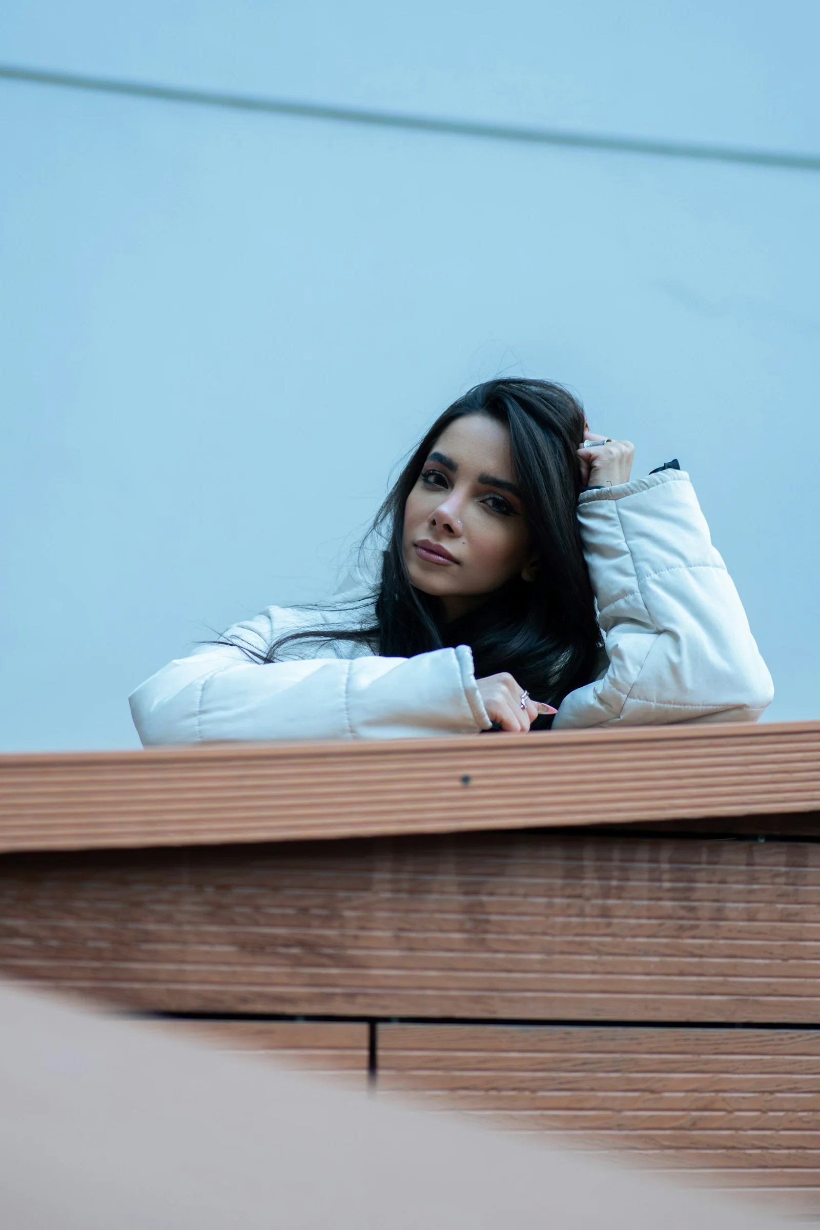 Woman rests her arm and gazes thoughtfully