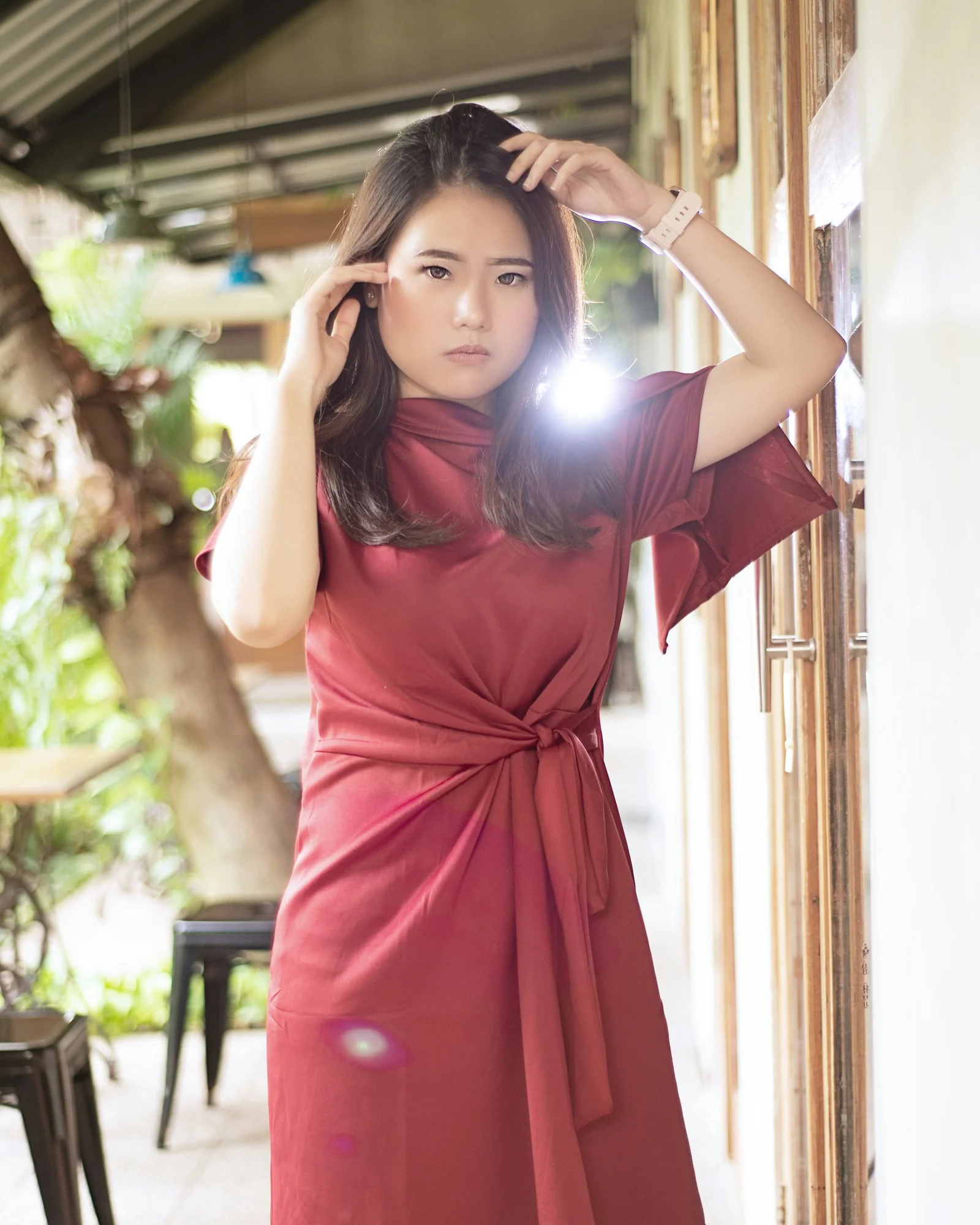 woman in red dress holding her hair