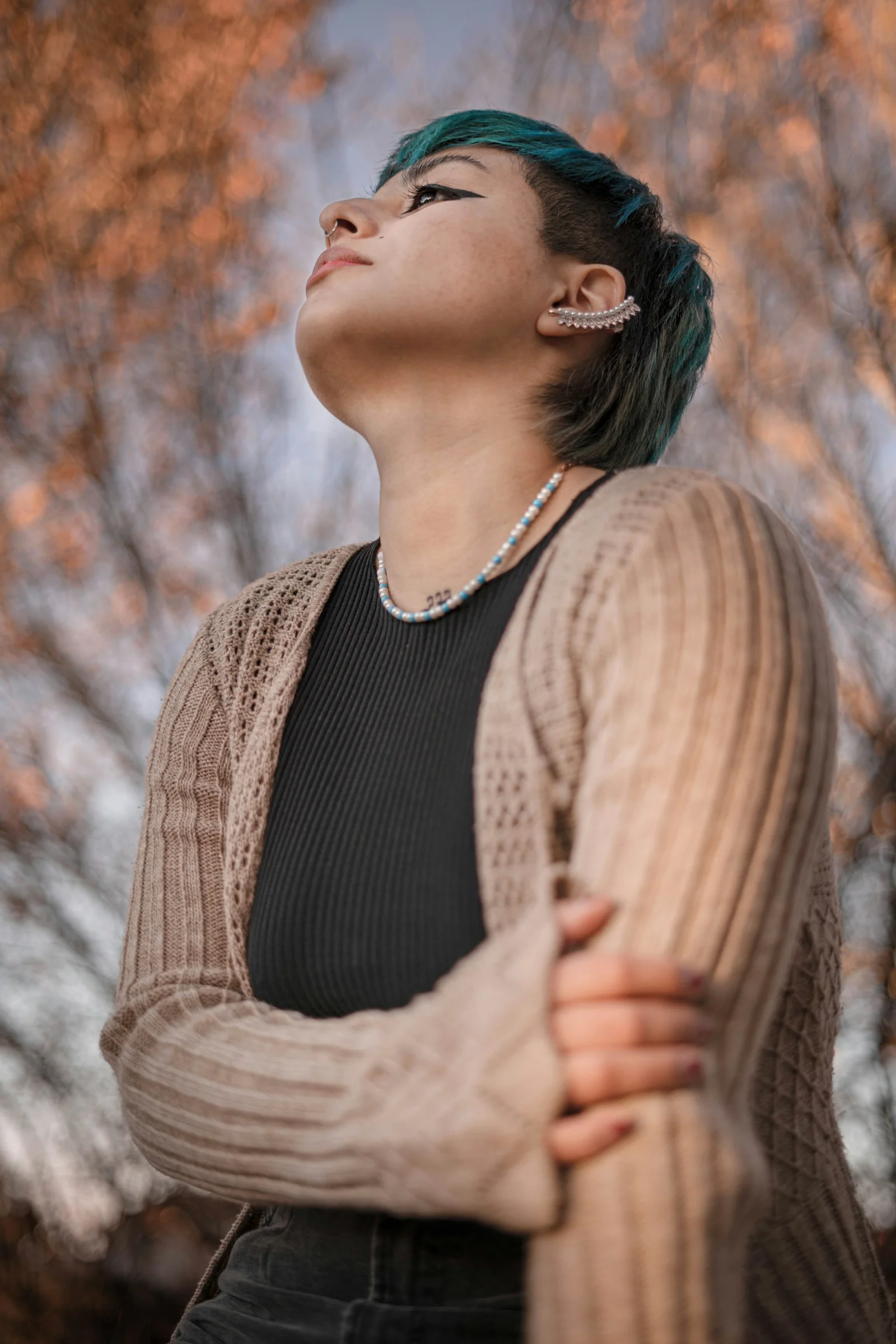a woman with green hair is looking up