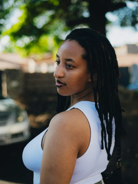 Woman with dreadlocks looking away from camera