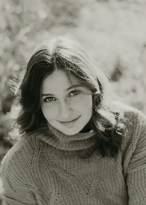 a black and white photo of a woman smiling