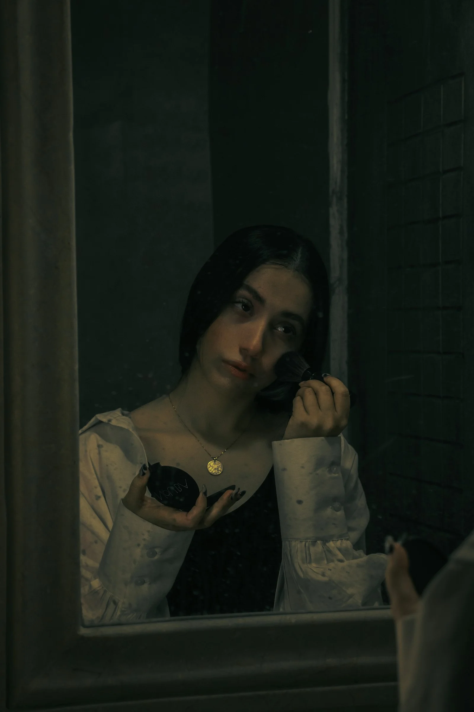 a woman looking in a mirror while brushing her teeth