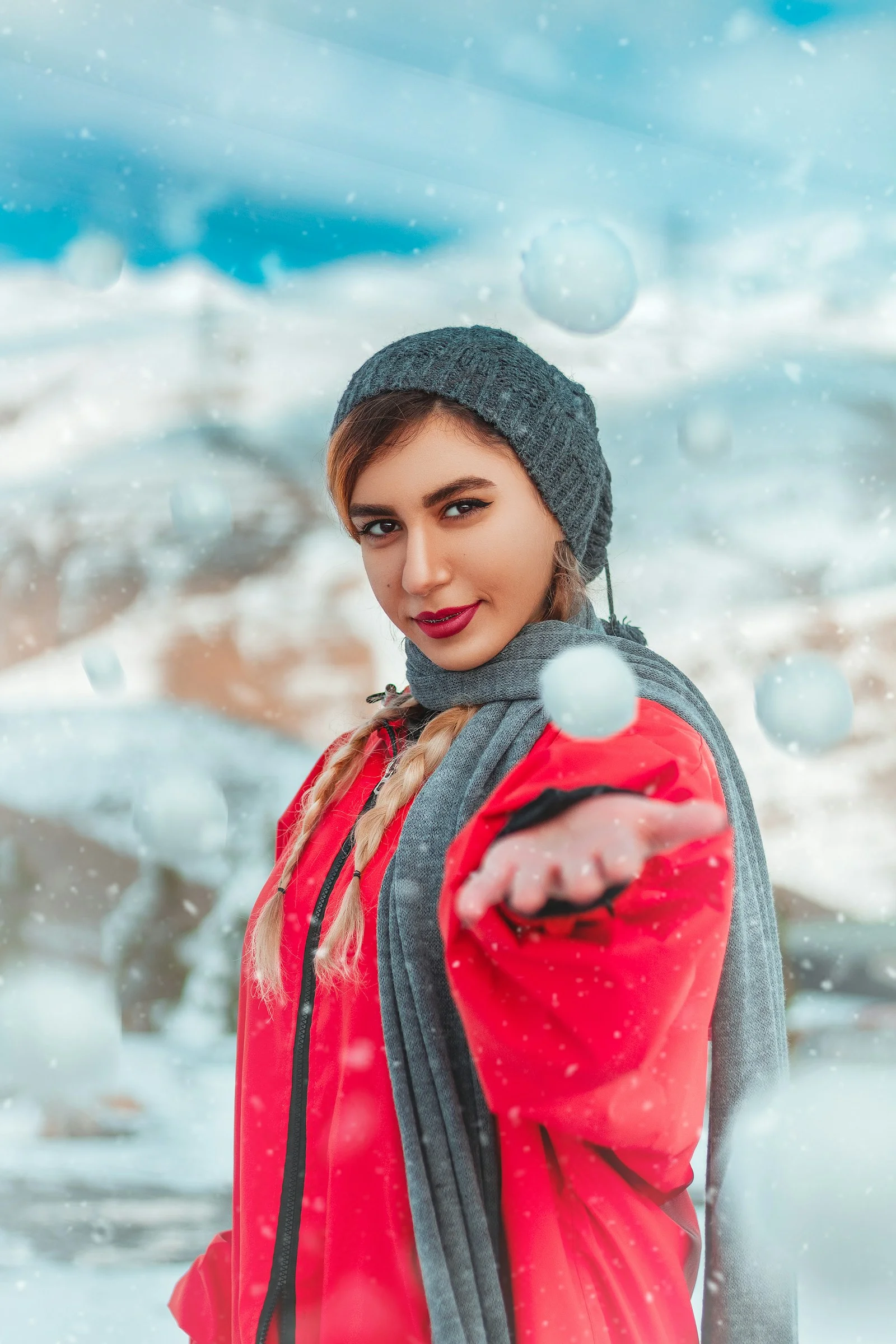 girl in red and black jacket and black knit cap