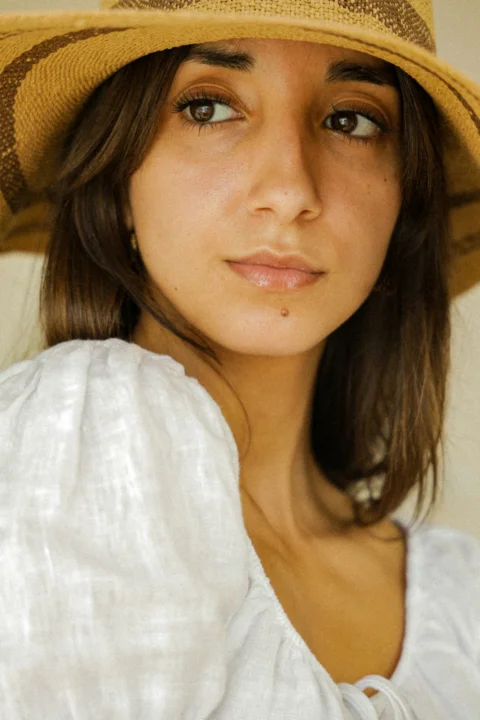 woman in white shirt wearing brown hat