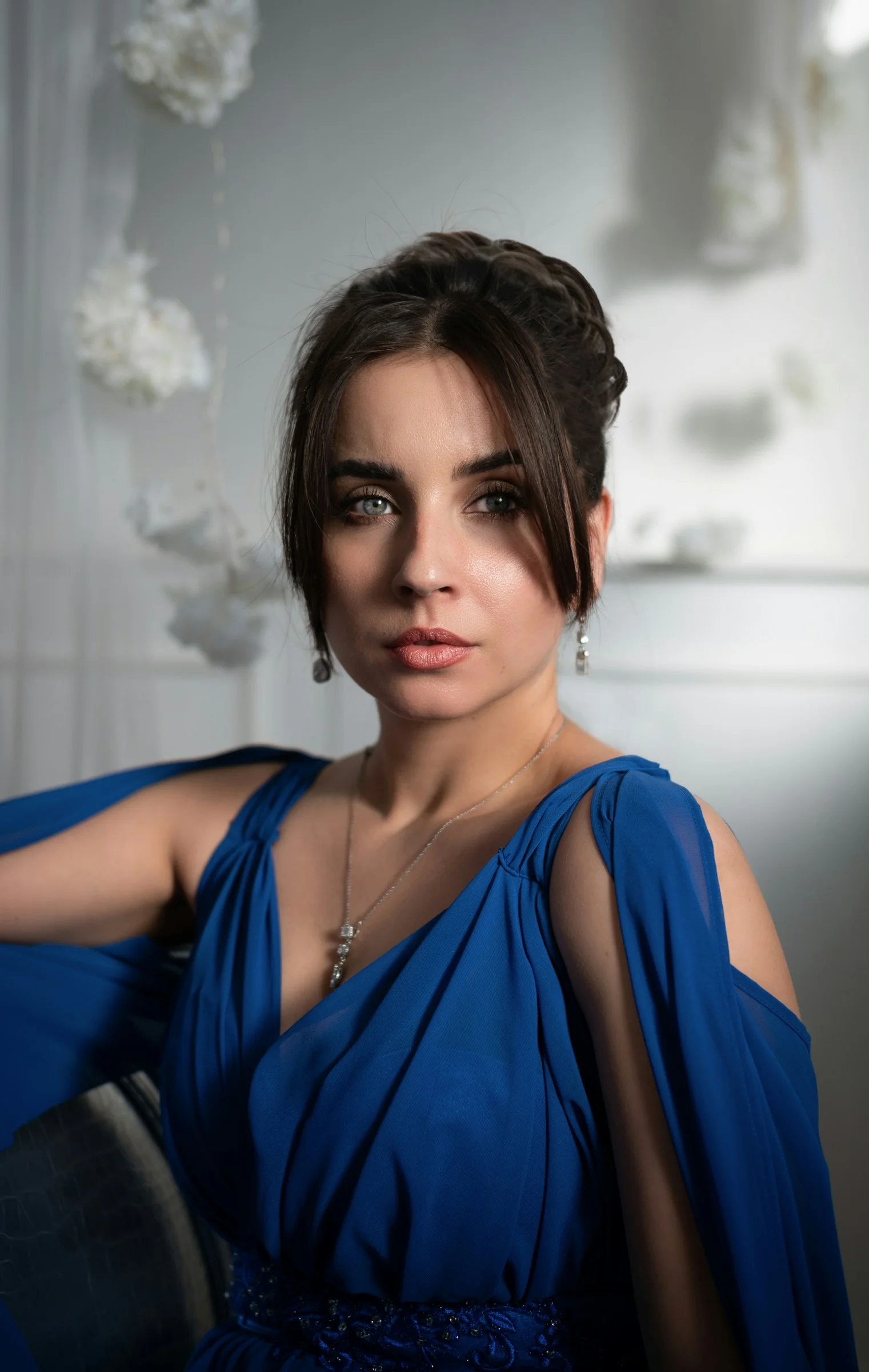 A woman in a blue dress posing for a picture