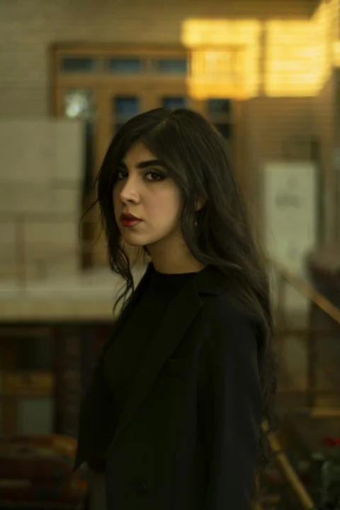 A woman with long hair standing in a room