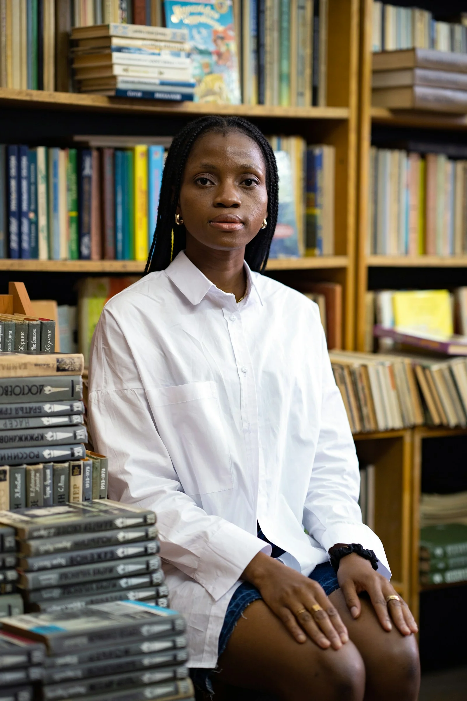 a person sitting in front of a bookshelf