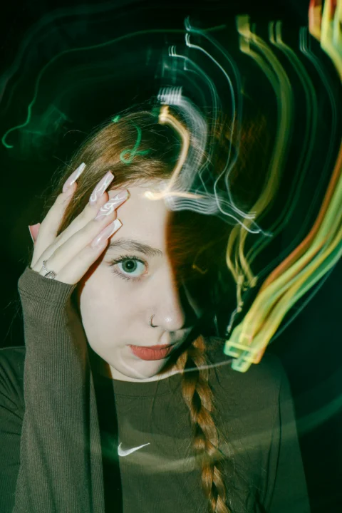 A woman with her hands on her head