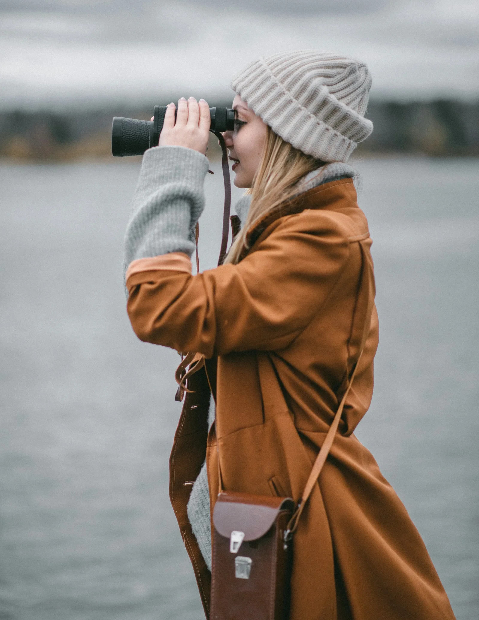 a person wearing a hat and holding a camera to the face