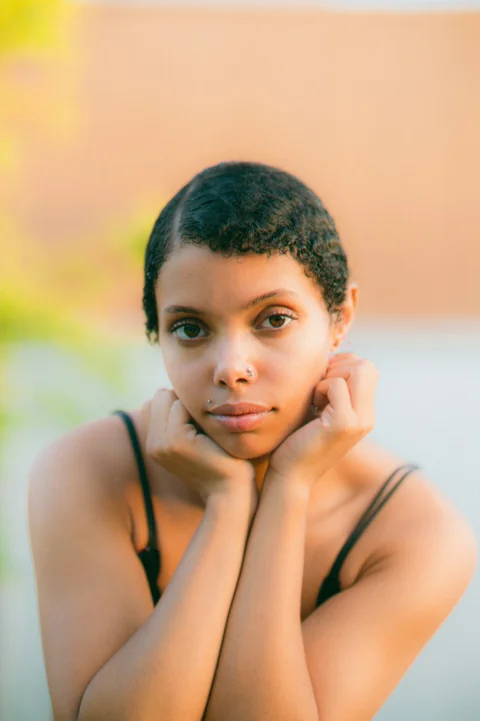 a woman with her hand on her chin