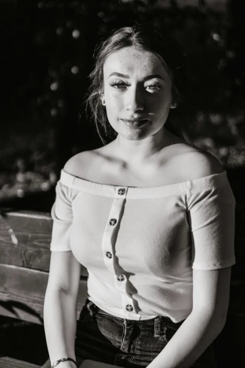 grayscale photography of woman wearing off-shoulder button-up shirt