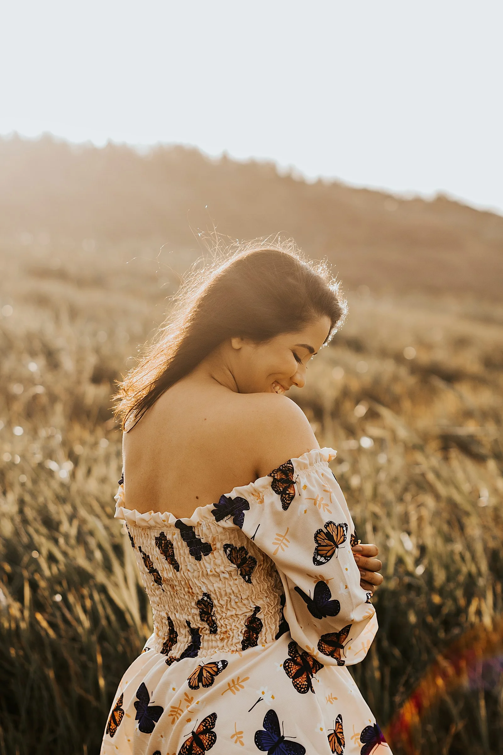 a woman standing in a field of tall grass