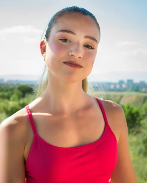 Young woman in pink tank top outdoors