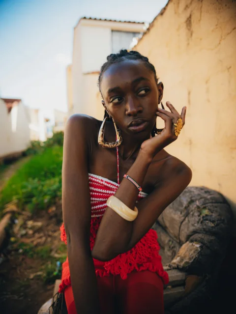 Young black woman wearing red and white outfit outdoors