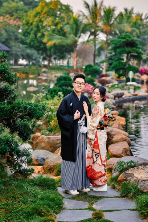 Couple in traditional japanese attire standing in a beautiful garden