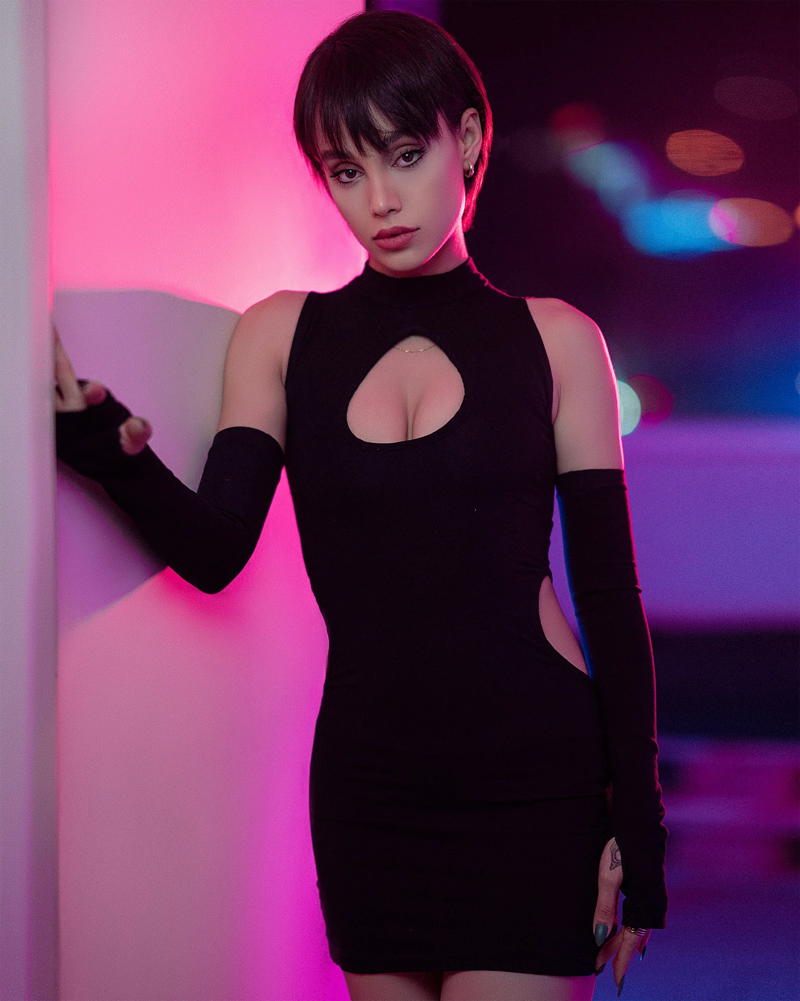 a woman in a black dress posing for a picture