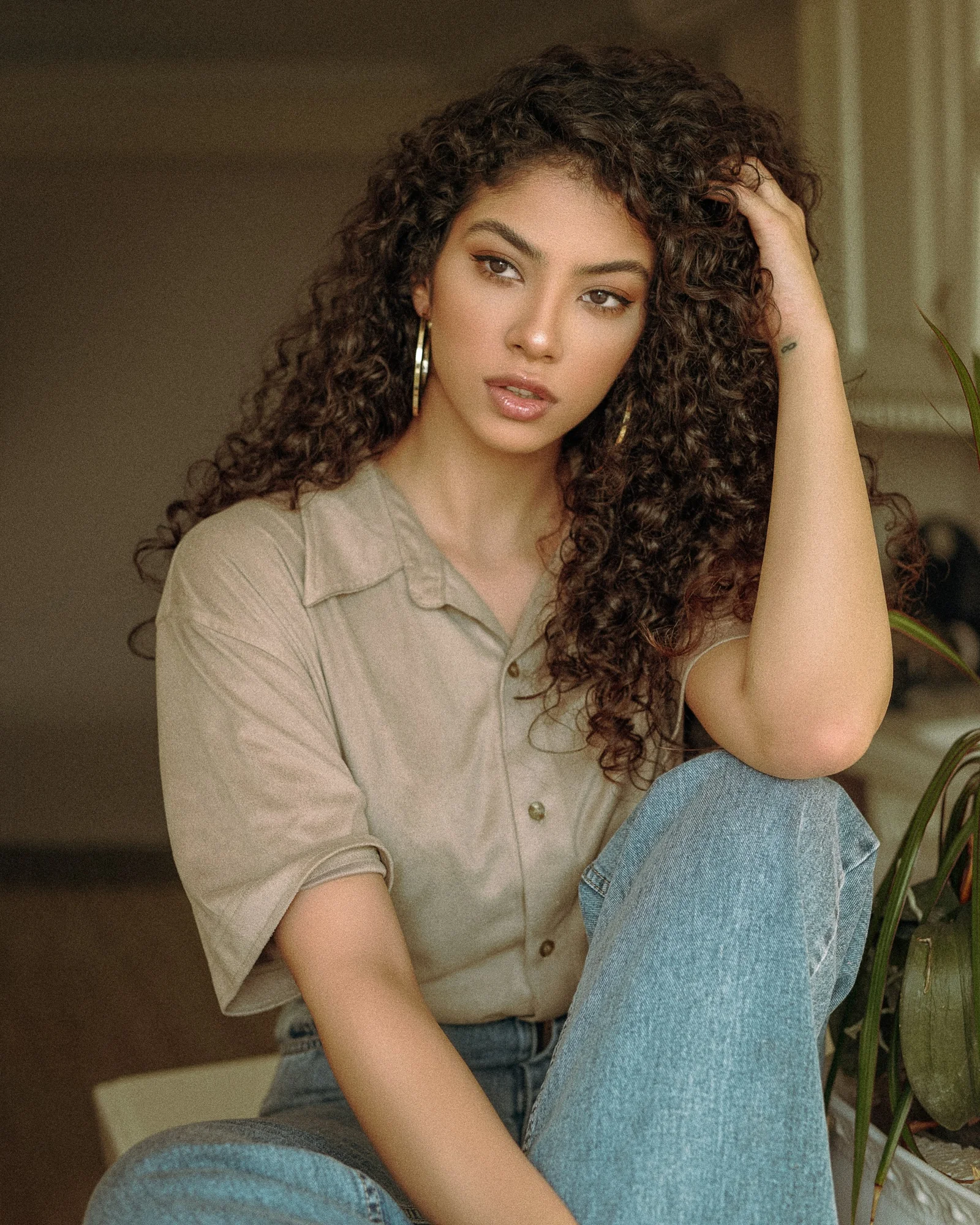 woman in brown button up shirt and blue denim jeans