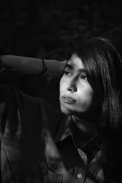 A black and white photo of a woman with long hair
