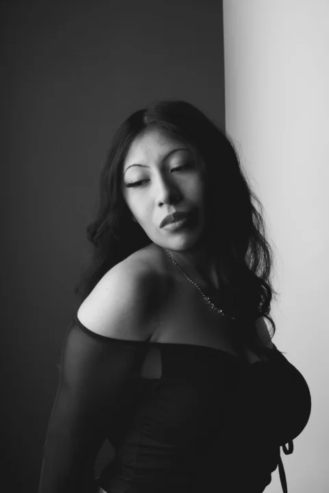A black and white photo of a woman with her eyes closed