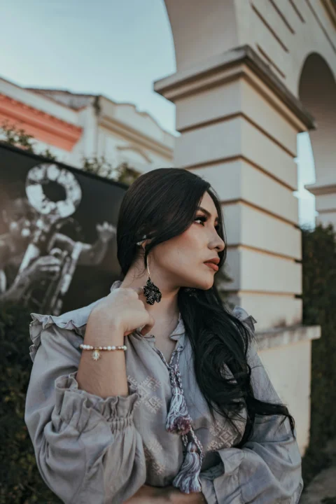 A woman poses in an architectural setting