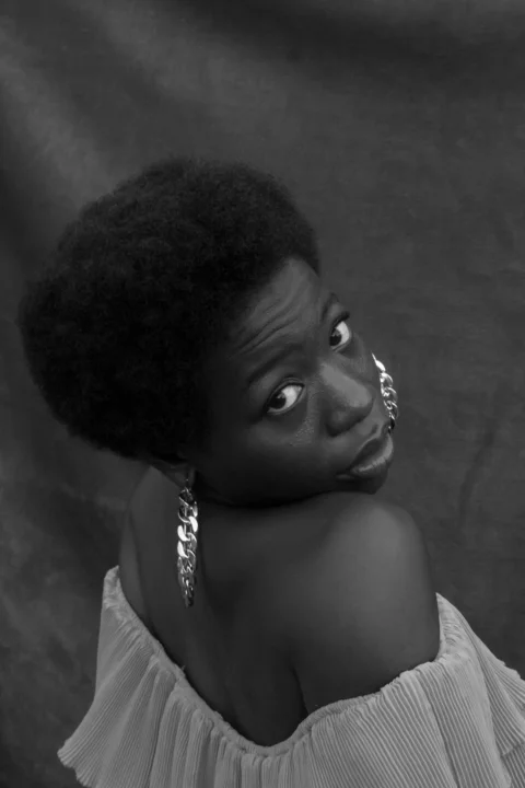 a woman with an afro is posing for a picture