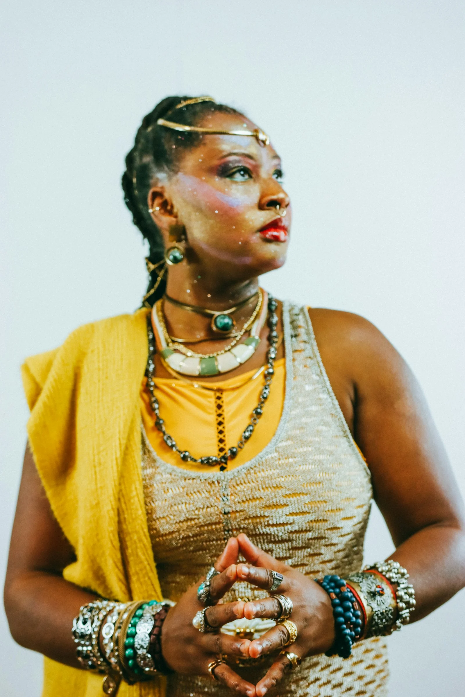 A woman adorned with jewelry and face paint