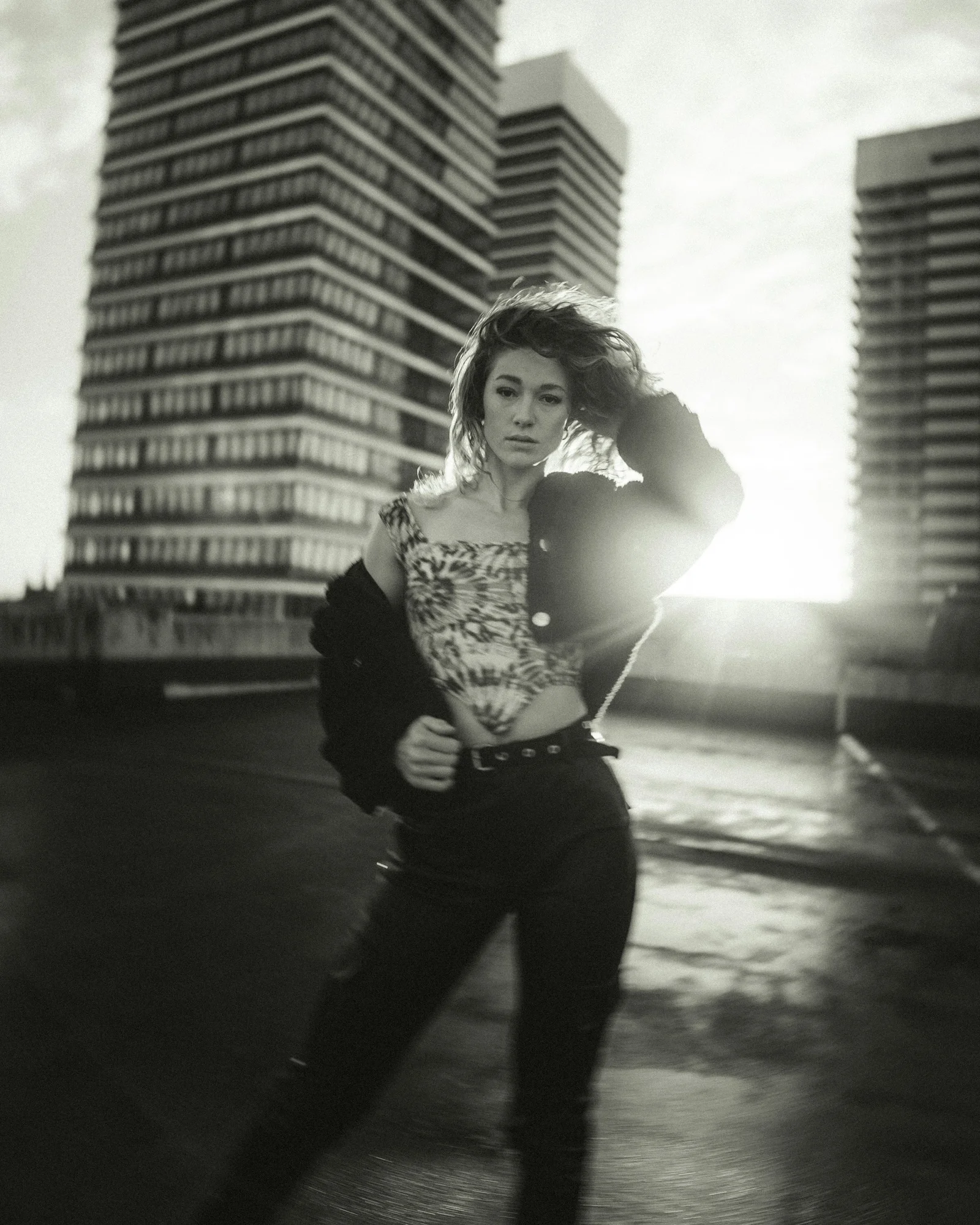 woman in black and white tank top and black pants standing on road