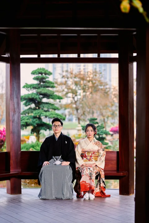 Couple in traditional japanese kimonos sitting on a wooden bench