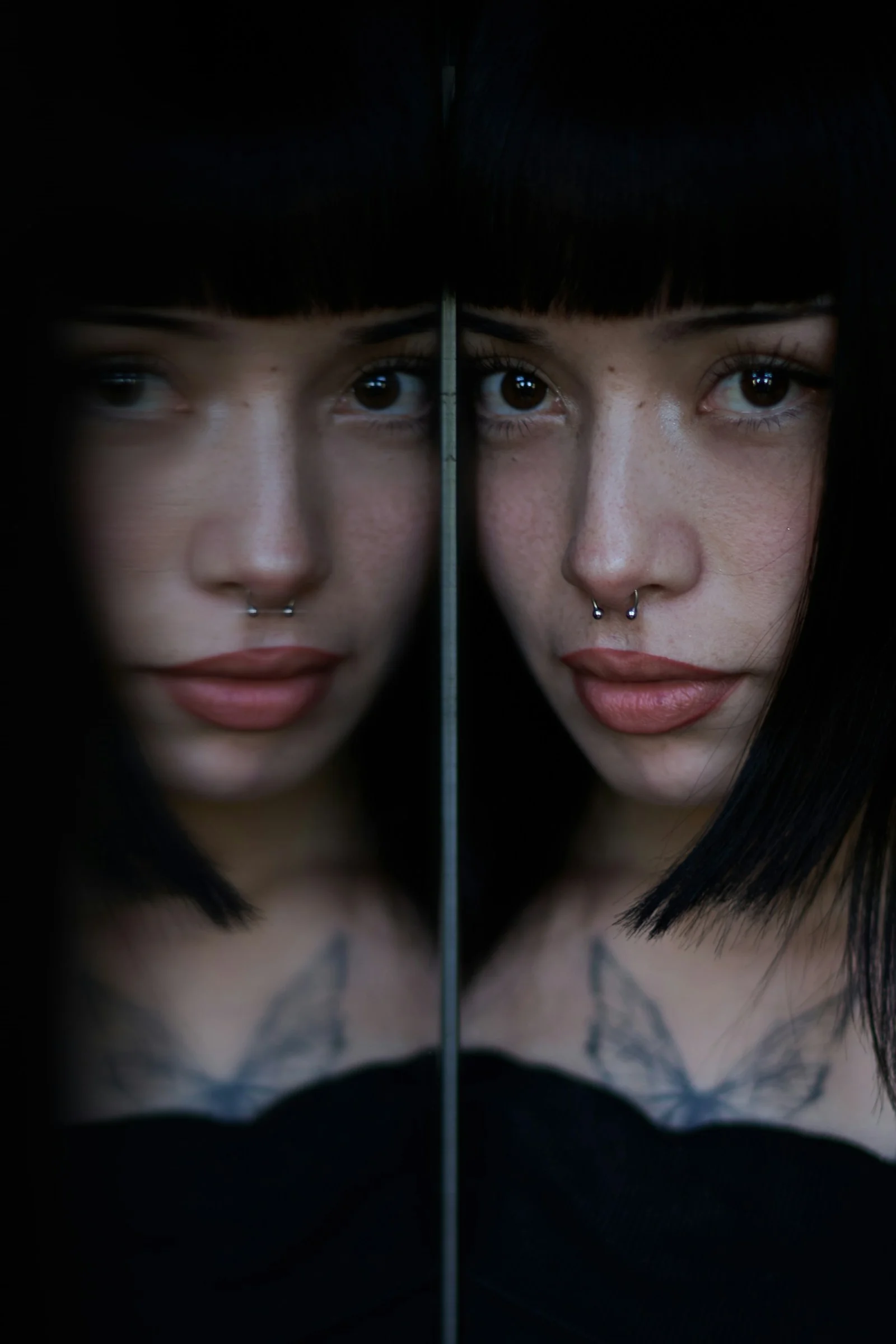 Young woman with dark hair and nose piercings