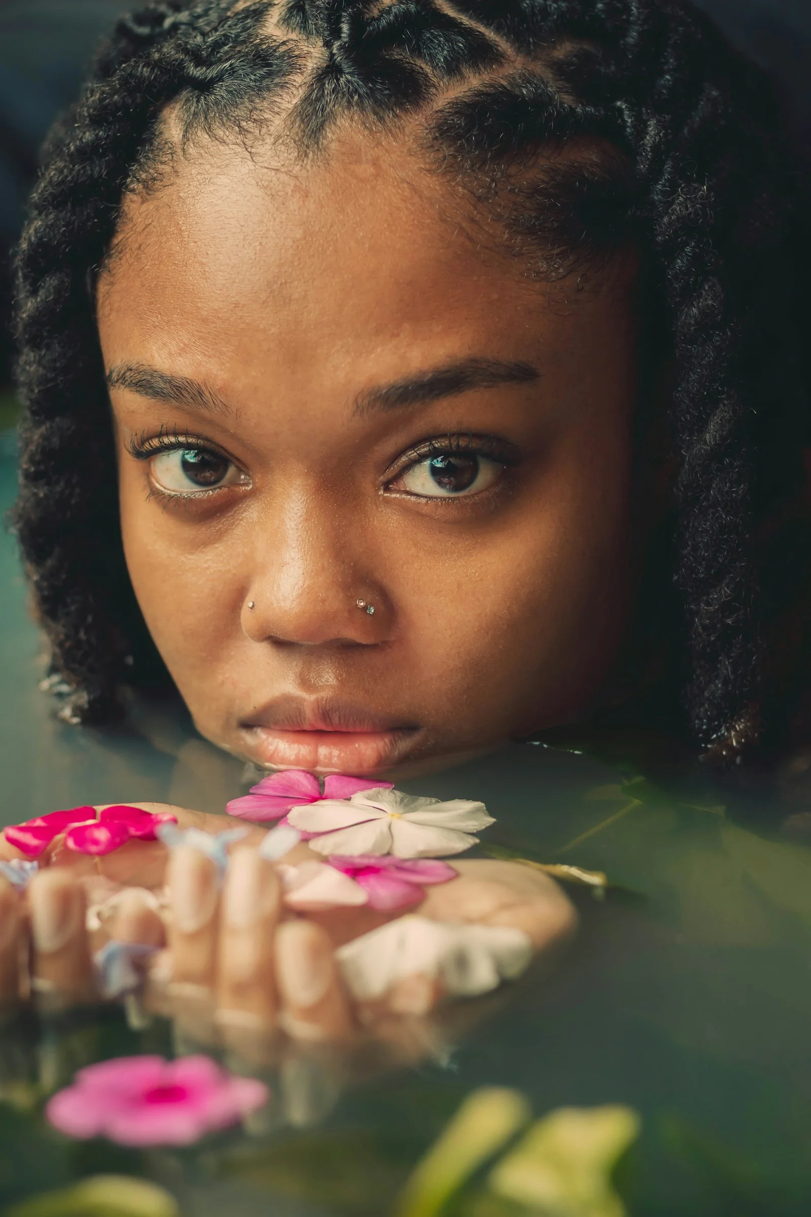 a young girl is holding flowers in her hands