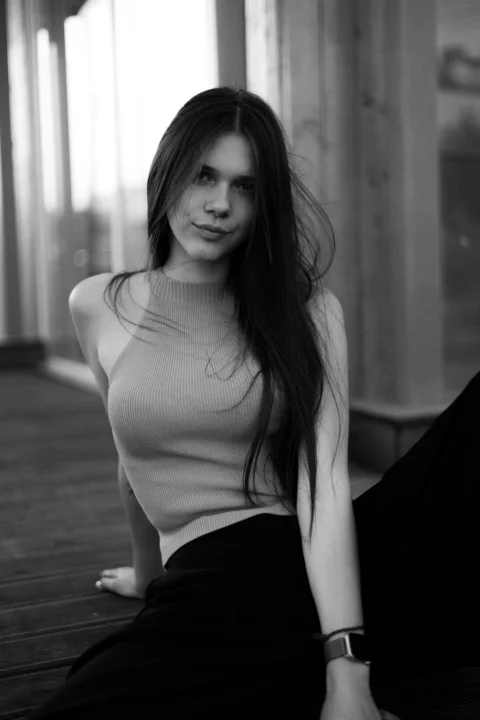 A young woman poses gracefully for the camera