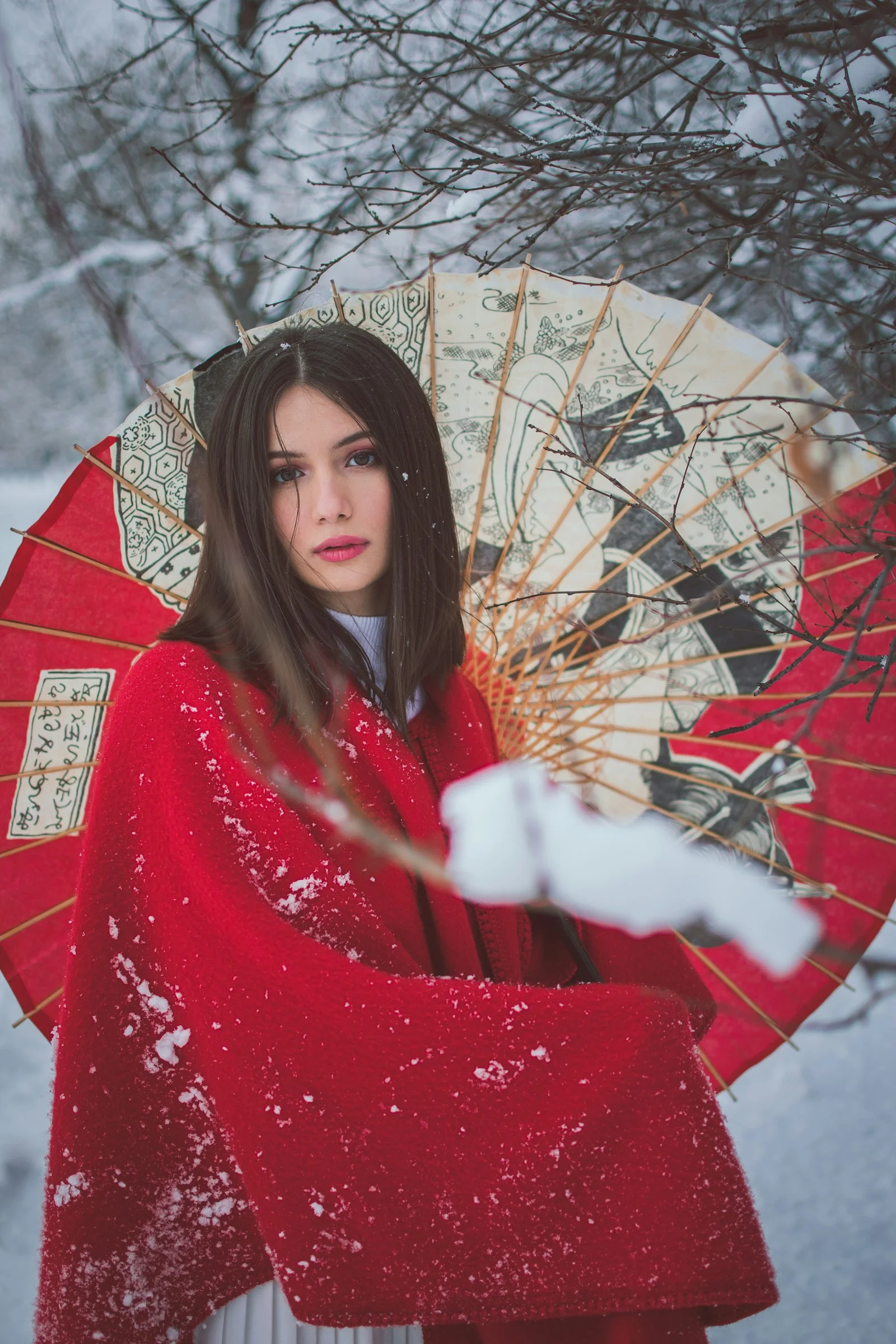 a woman in a red kimono holding an umbrella