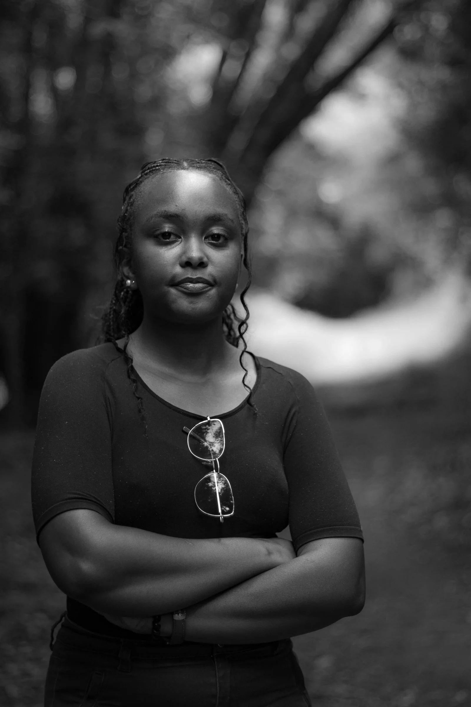 A black and white photo of a woman with her arms crossed
