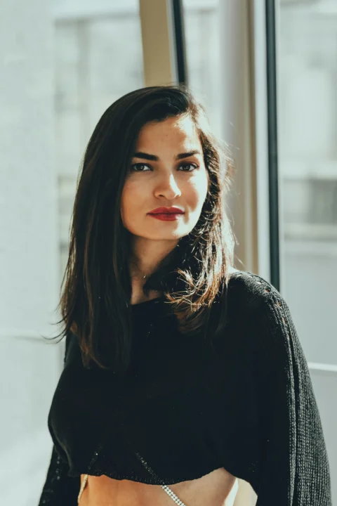 a woman standing in front of a window