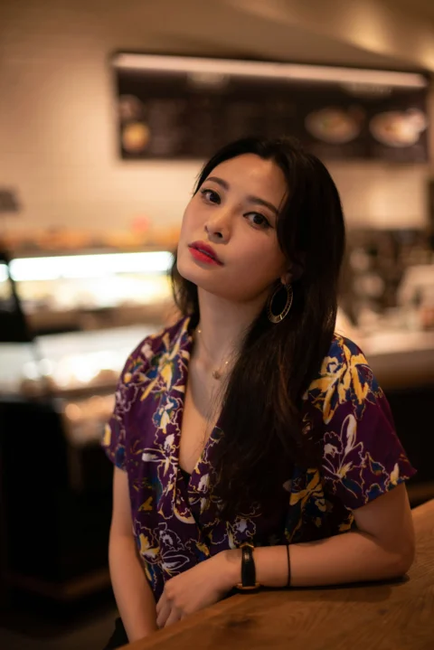 a woman sitting at a bar with her arms crossed
