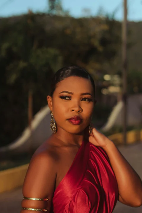 a woman in a red dress posing for a picture