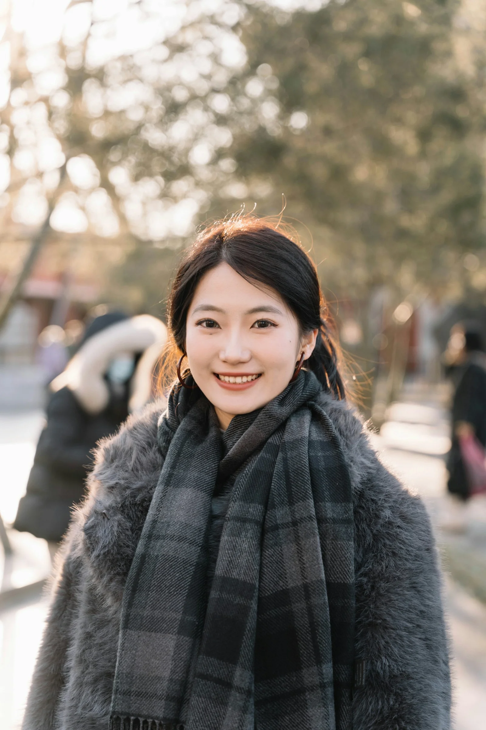 Young woman smiling outdoors in winter clothing