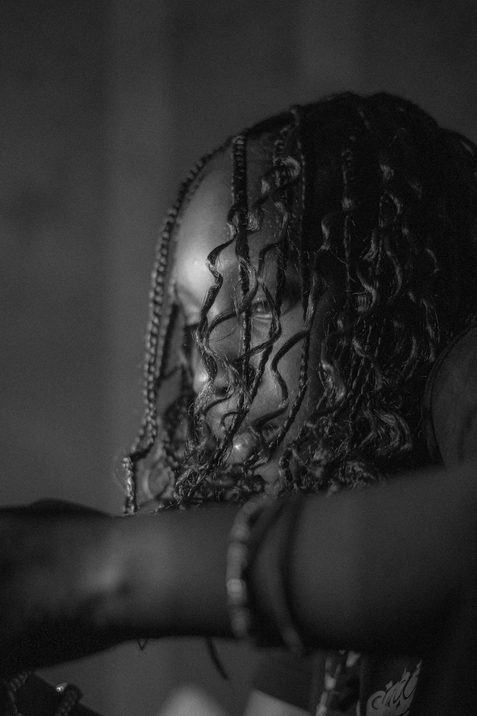 Close-up of a person with braided hair and arms