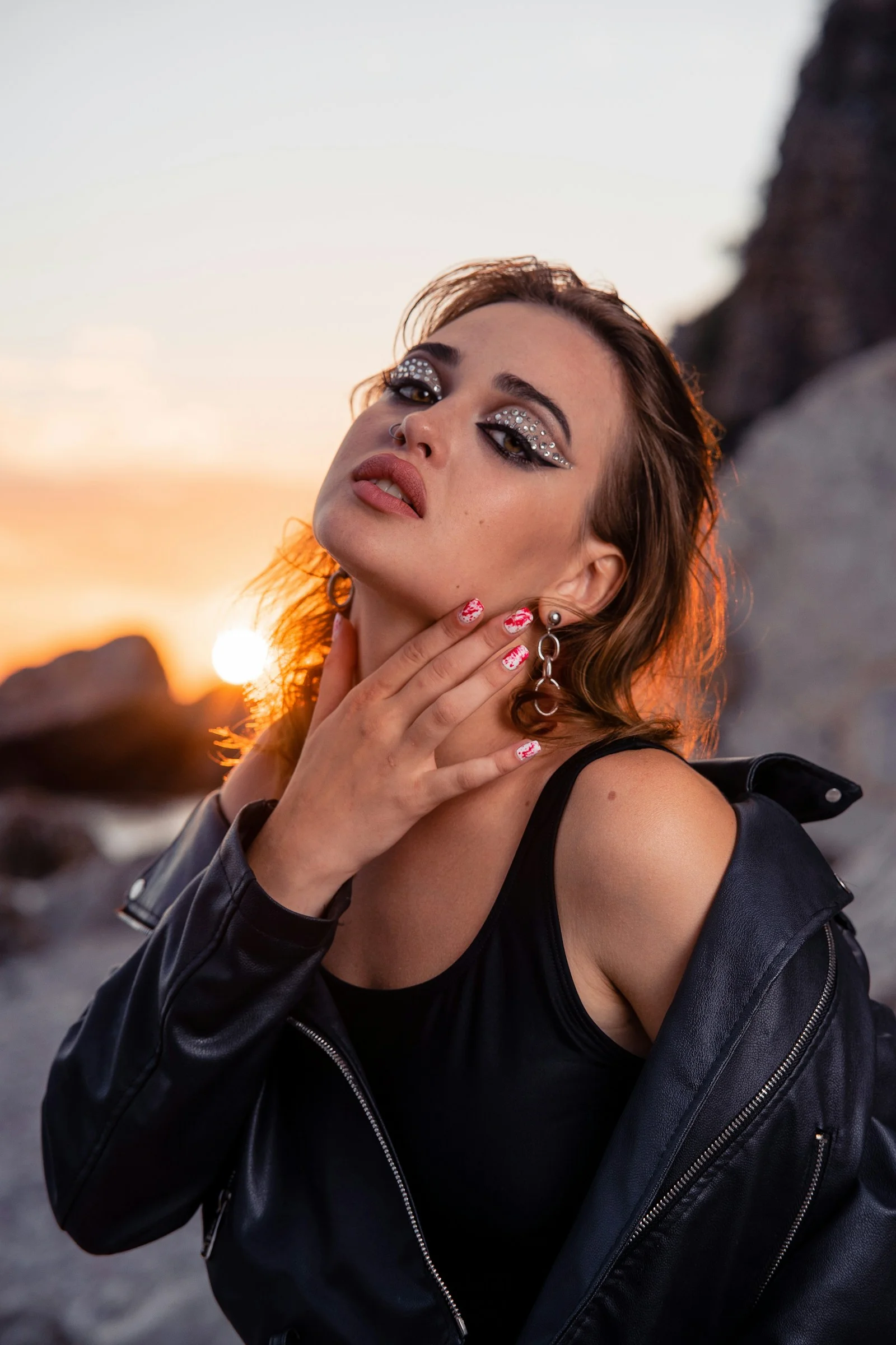Woman with dramatic makeup at sunset
