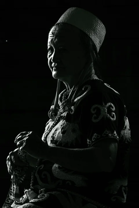 A black and white photo of a woman sitting in a chair