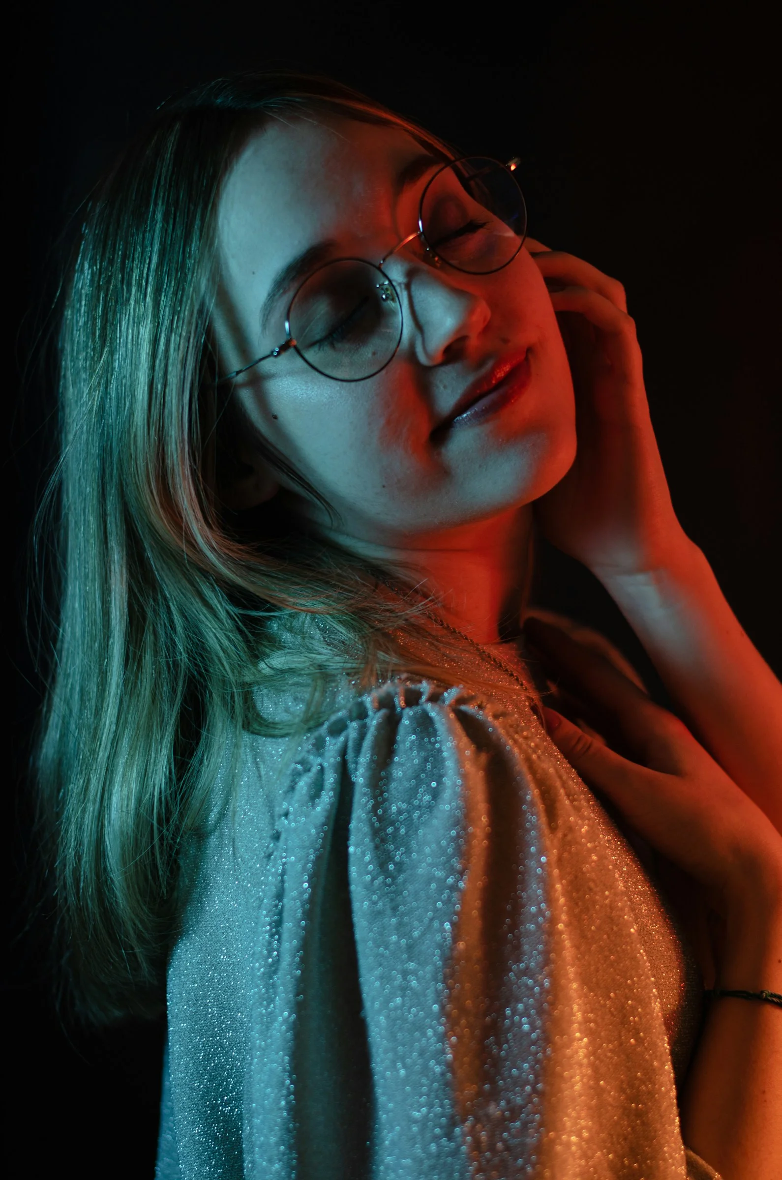 a woman wearing glasses is posing for a picture