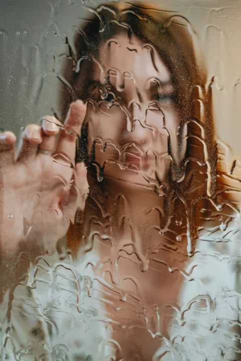 A woman touches a wet surface